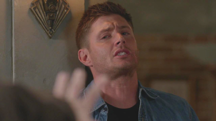 Gadreel pins Dean to the wall.